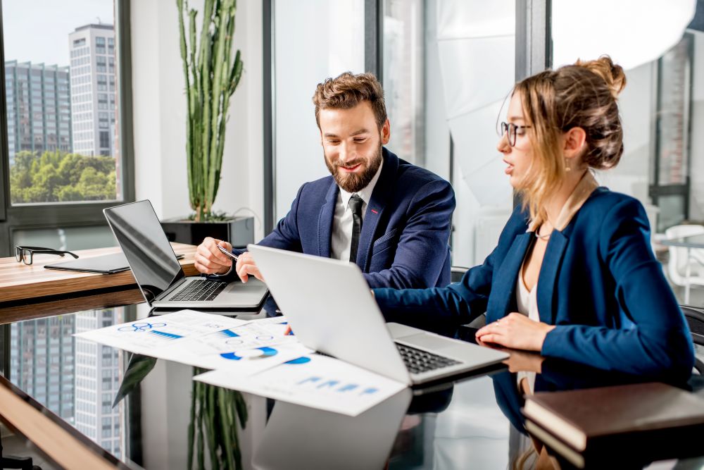 Two business workers talking at a desk