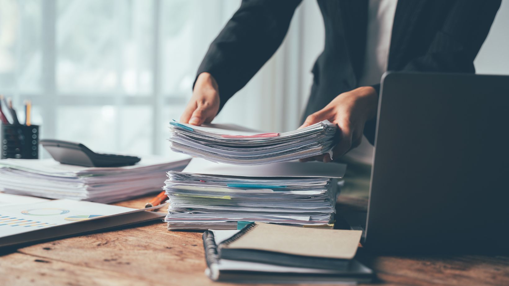 Home office worker with a stack of paperwork
