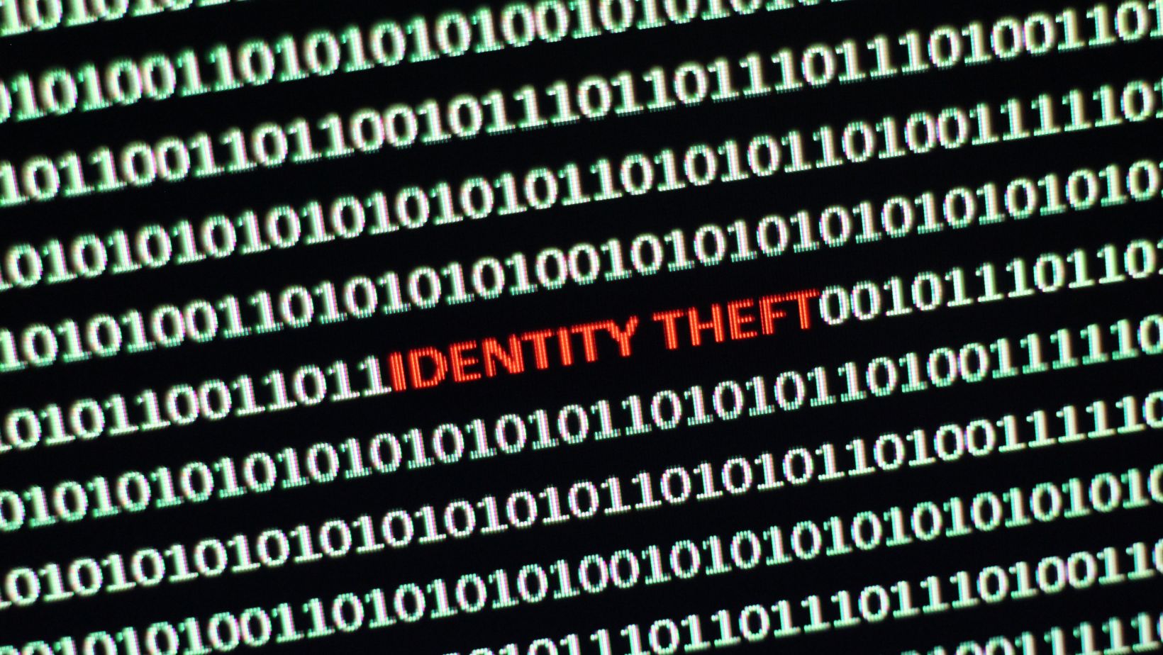 binary code with the words "identity theft" in the middle
